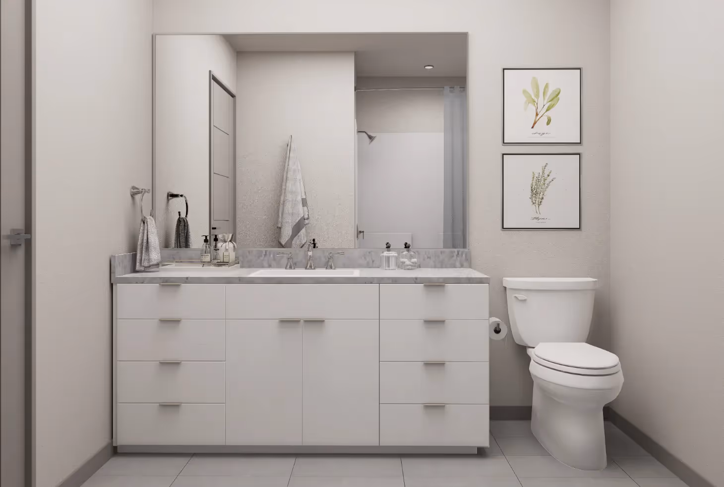 Apartment bathroom with a double vanity, white cabinets, and a toilet, showcasing the clean, modern design at Avian Apartments in Colorado Springs, CO.